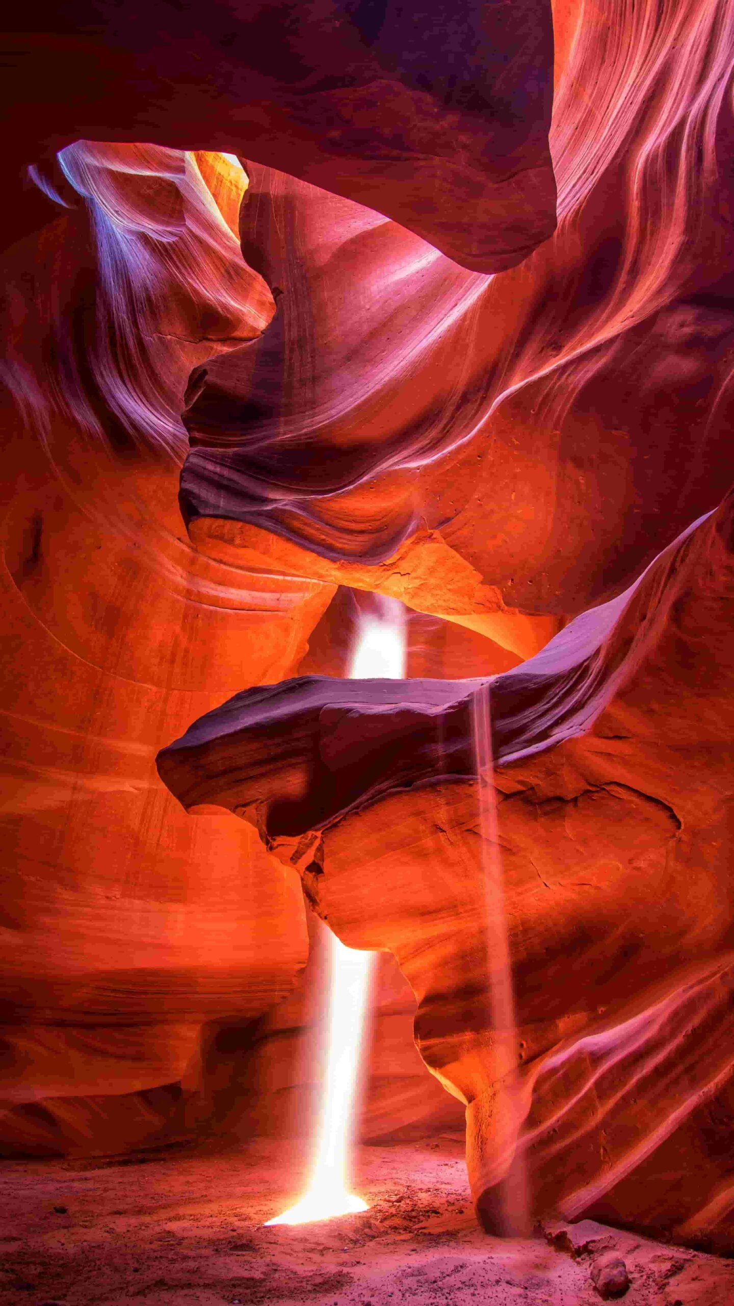 The beams of direct sunlight radiating down from the openings of Upper Antelope Canyon